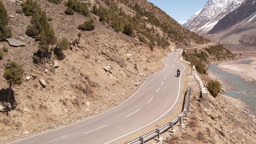 Rider on a motorcycle with Himalayan mountain scenery