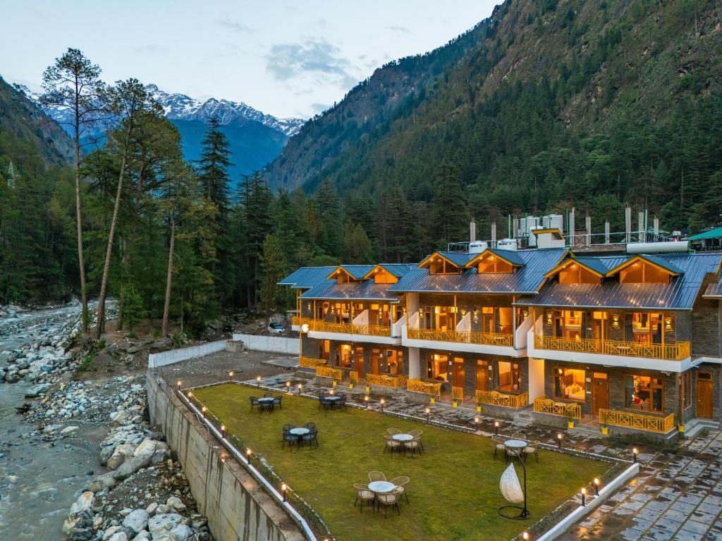 Kasol town with snow-capped peaks and pine forests